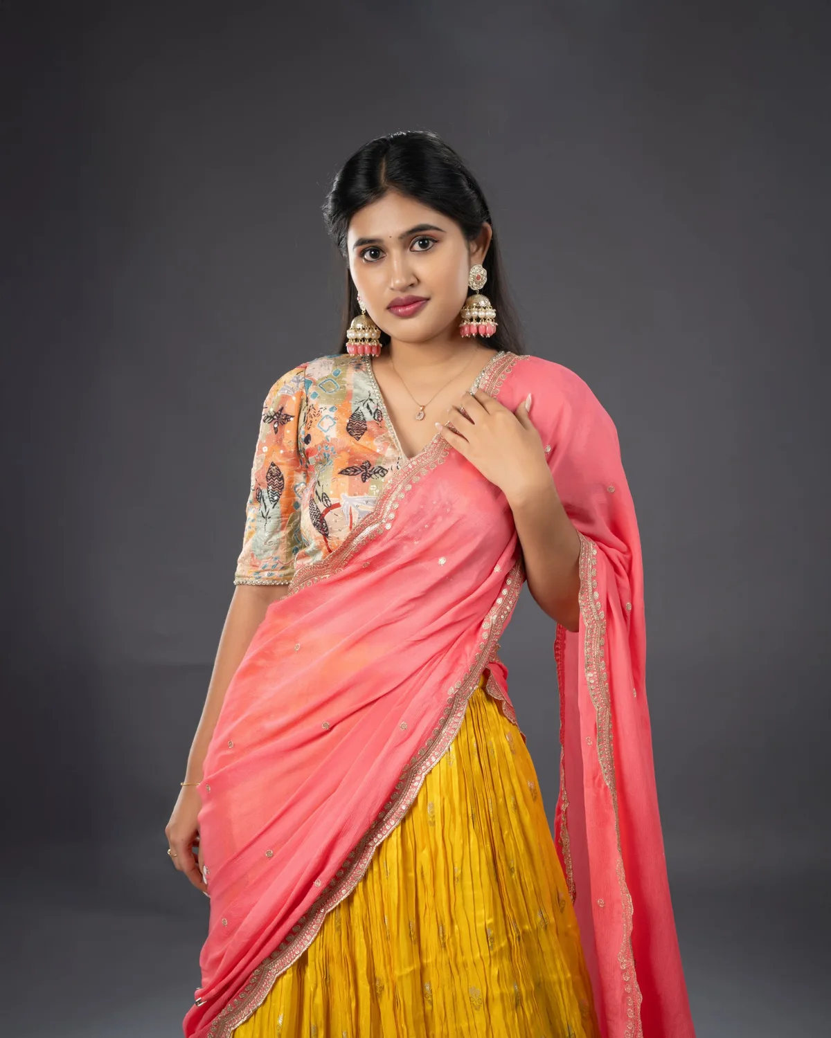 Fashion portrait in a coral sari with traditional styling