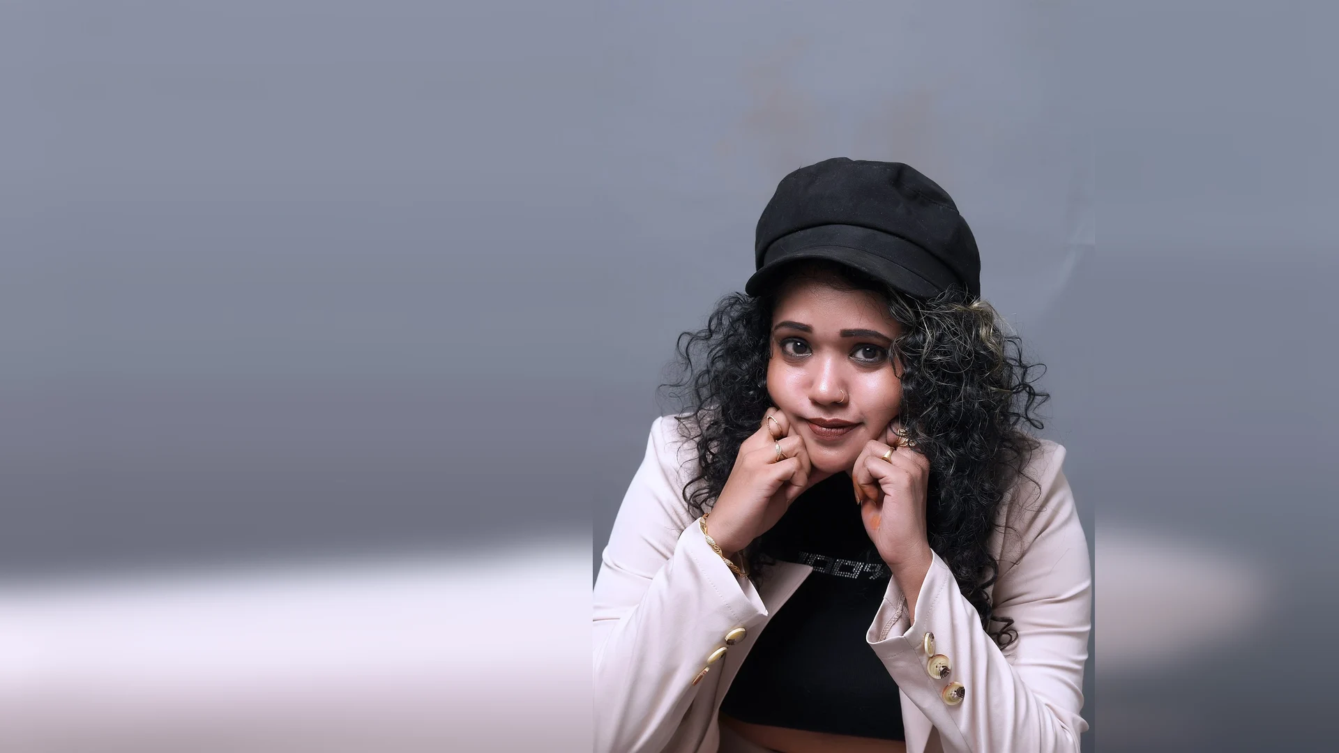 Expressive close-up portrait in a black cap by Lens Chronicle